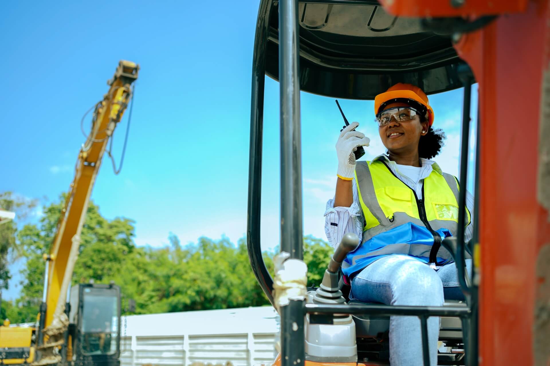 woman worker driving backhoe dig hole